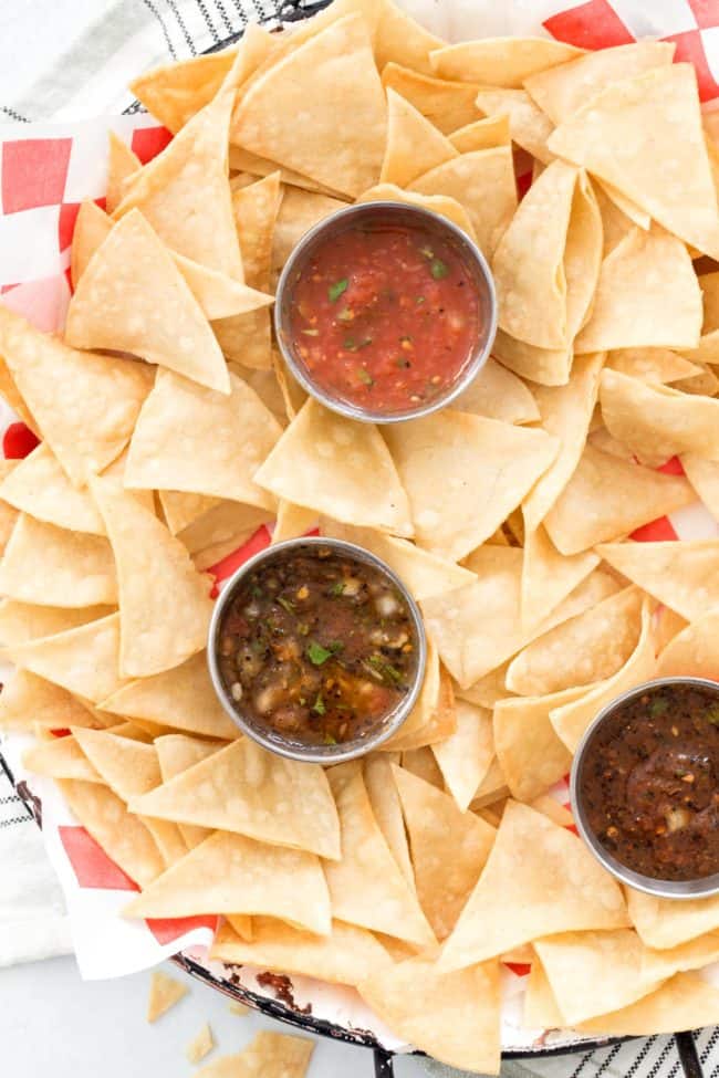 A platter of corn tortilla chips and salsa.