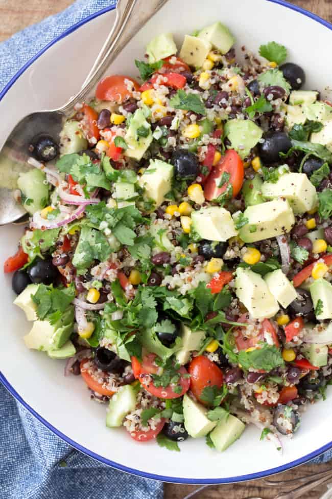 A white bowl filled with black bean quinoa salad.