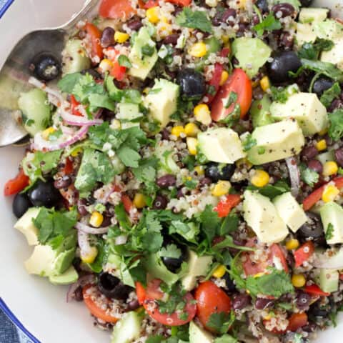 A white bowl filled with quinoa black bean salad.