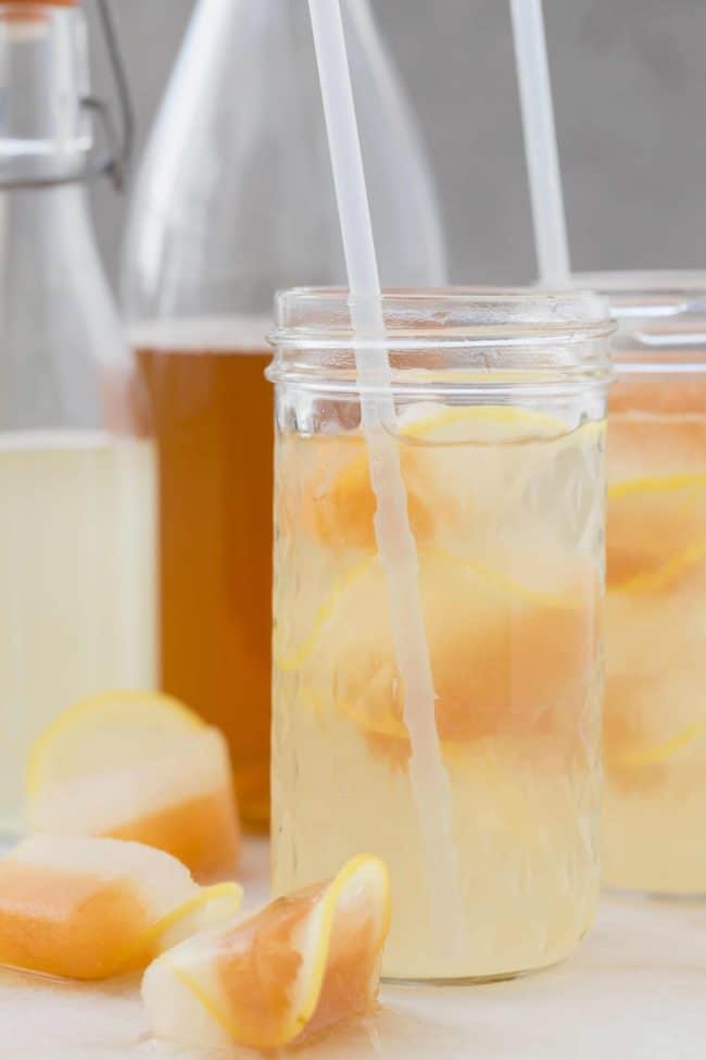 Two clear drinking glasses filled with lemonade.