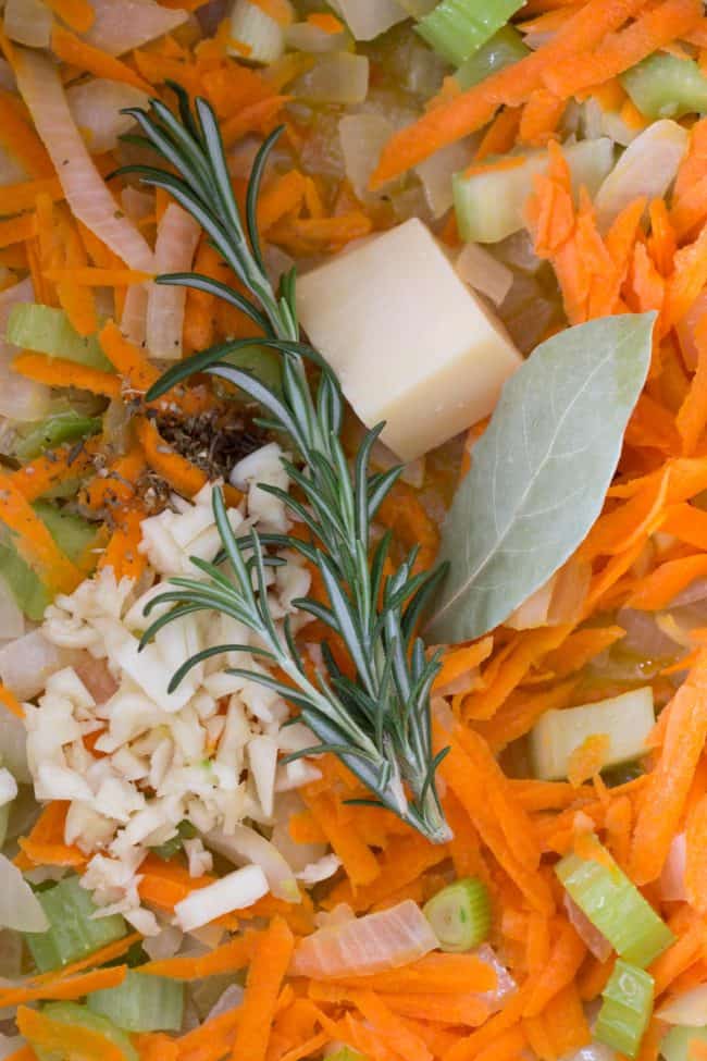 Grated carrot, chopped celery and onion in a large pot.