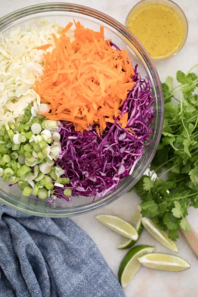 bowl of shredded vegetables for cabbage slaw