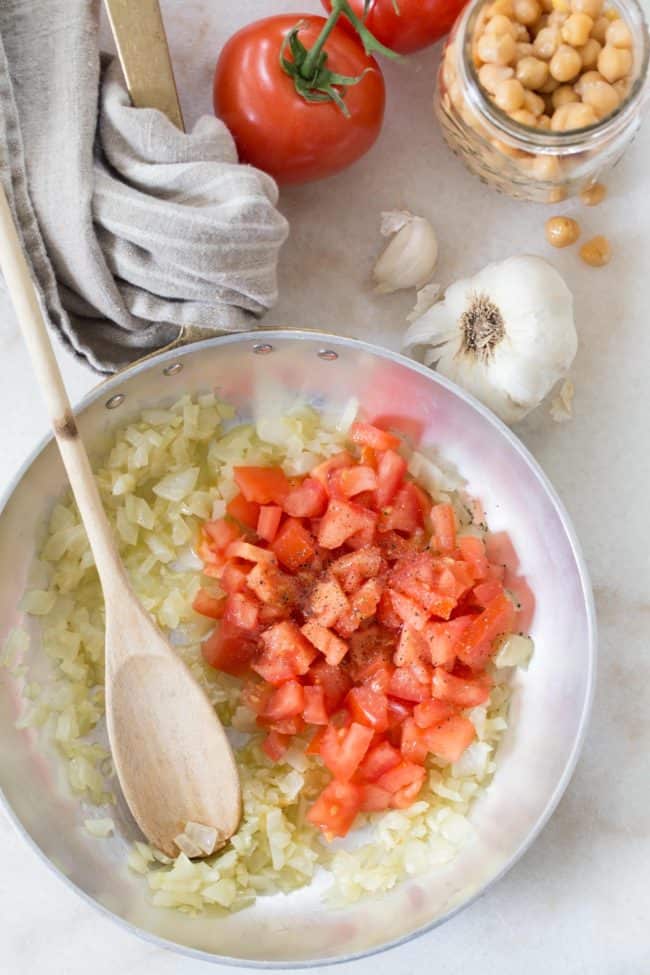 skillet of cooked onions and tomatoes