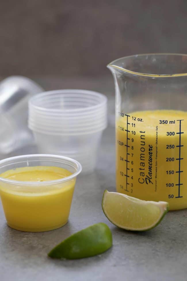 Glass measuring cup filled with pineapple ginger juice.