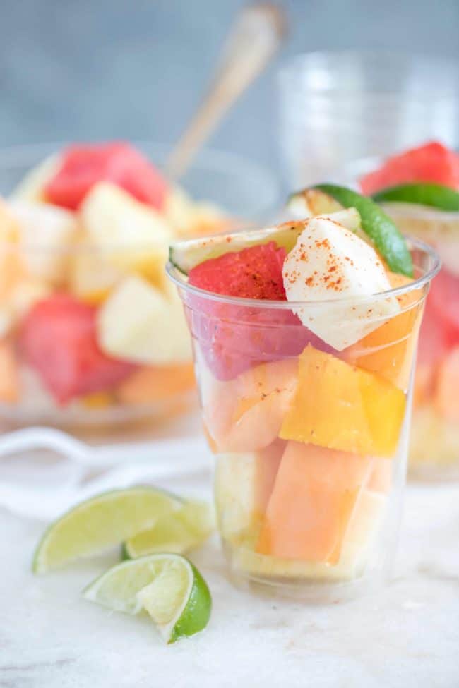 Clear plastic glasses filled with chopped watermelon.