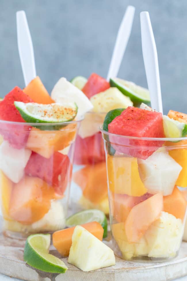 Mexican fruit cups filled with watermelon and pineapple.