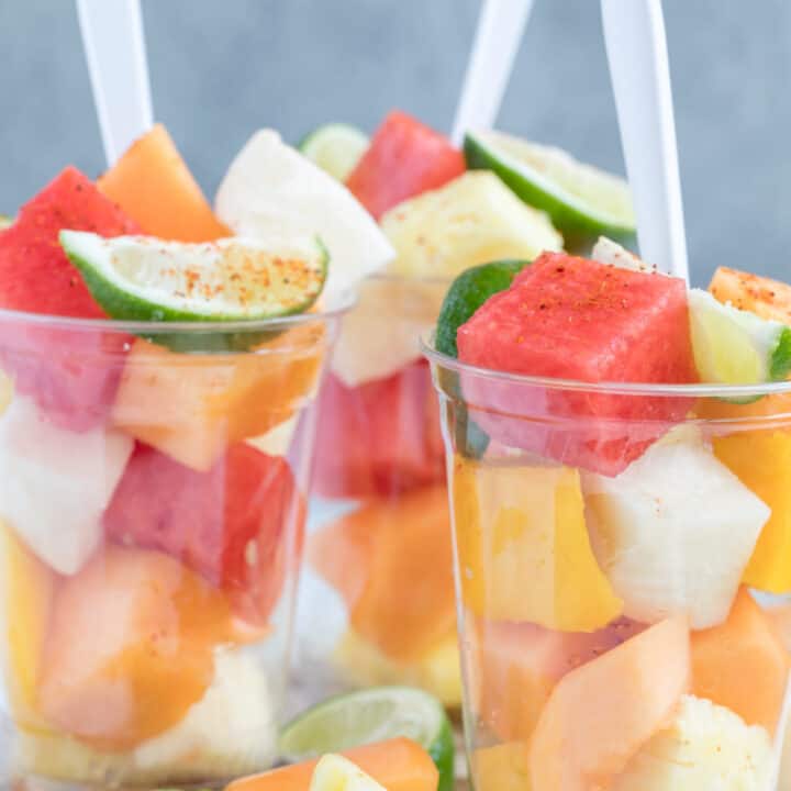 Healthy fruit cups filled with watermelon and pineapple.