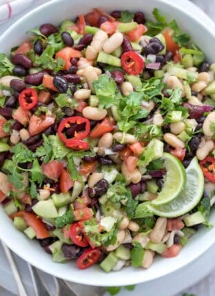 A white bowl filled with Mexican Bean Salad.