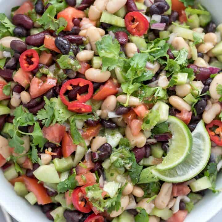 A white bowl filled with Mexican Bean Salad.