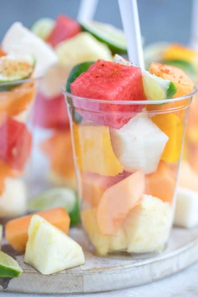 plastic drinking glasses filled with fresh fruit salad