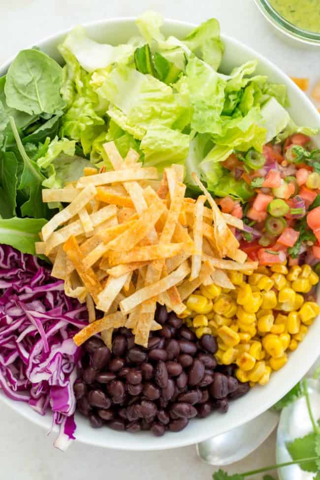 white bowl filled with Mexican salad ingredients