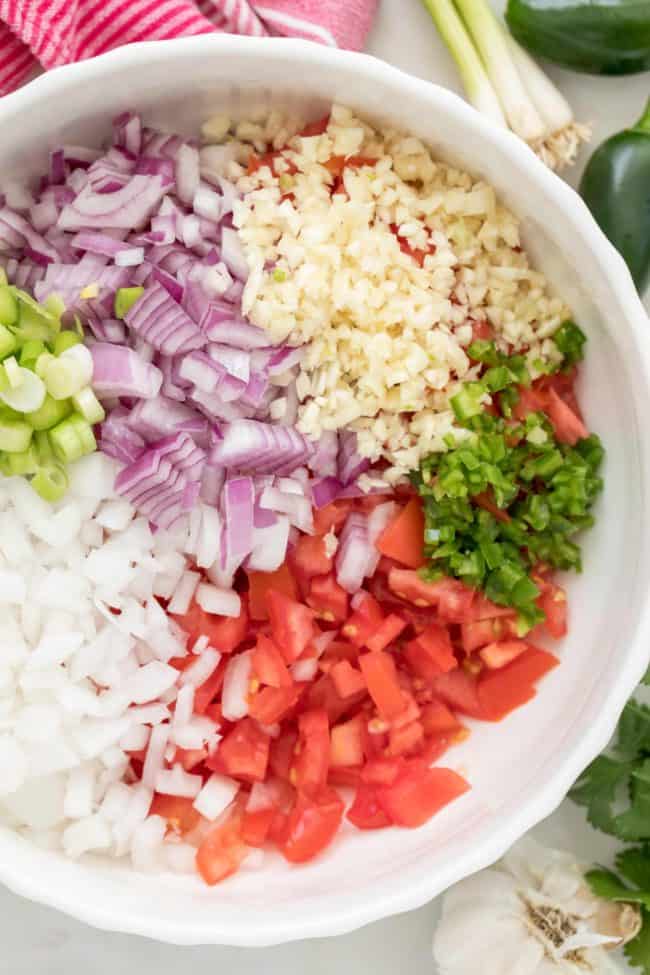 This easy Pico de Gallo Recipe (also referred to as salsa fresca) is a versatile recipe that's made with fresh tomatoes, onion, garlic, jalapeno, cilantro and lime juice