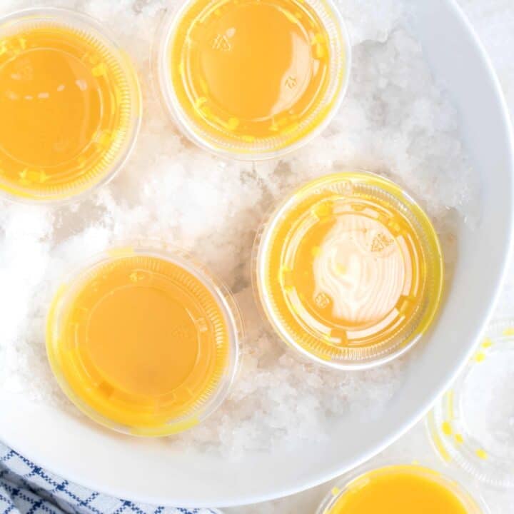 Four small cups of ginger turmeric shots.