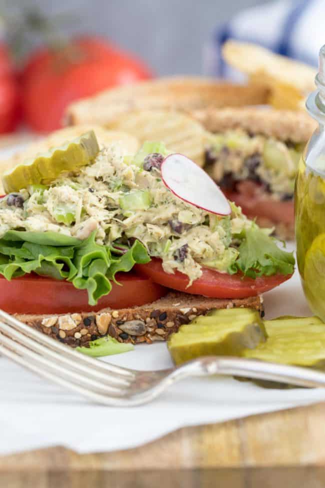 healthy tuna salad sandiwch with tomatoes and pickles