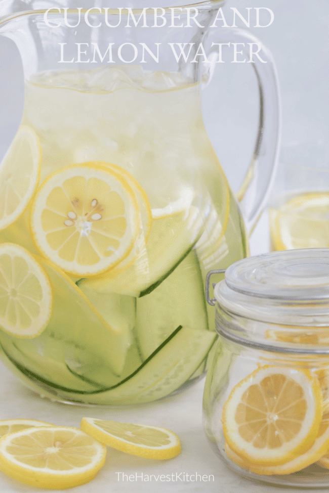 A glass pitcher filled with sliced citrus fruit.
