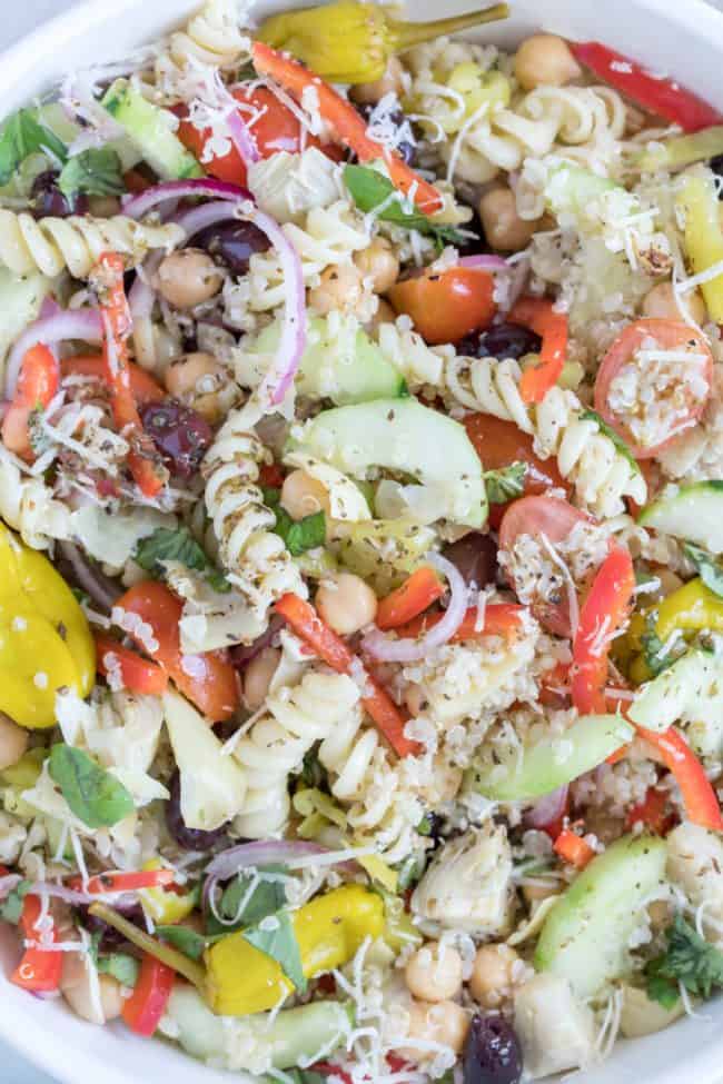 A white bowl of quinoa and pasta salad.
