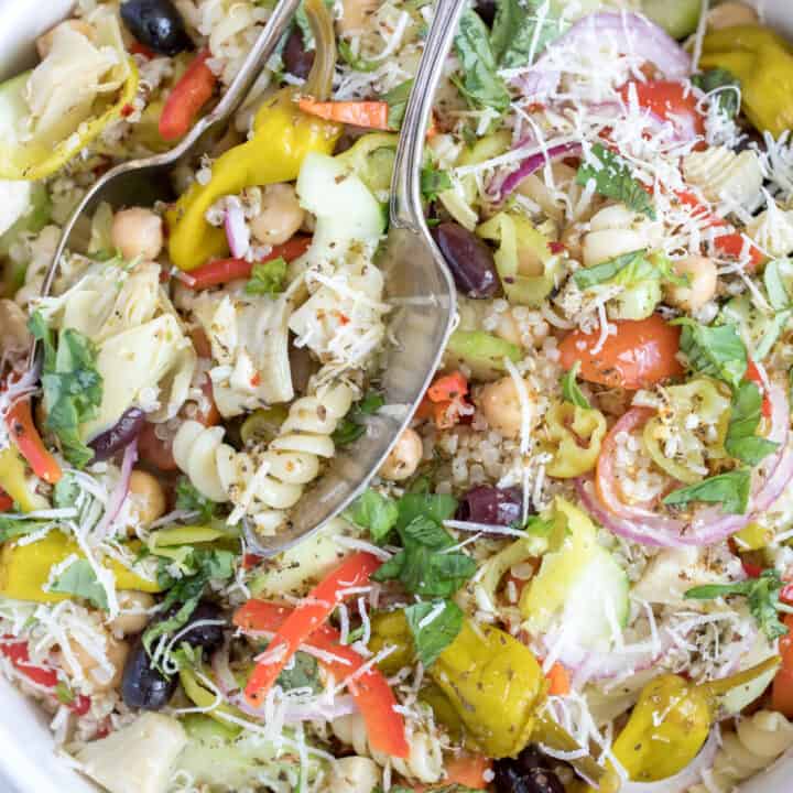 A white bowl of quinoa and pasta salad.