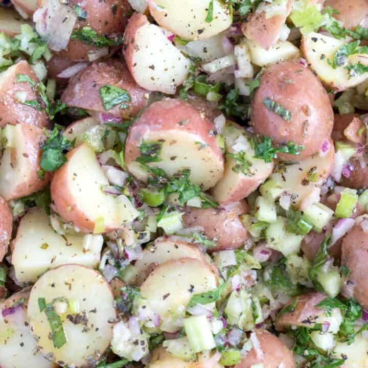 A bowl filled with red potato salad.