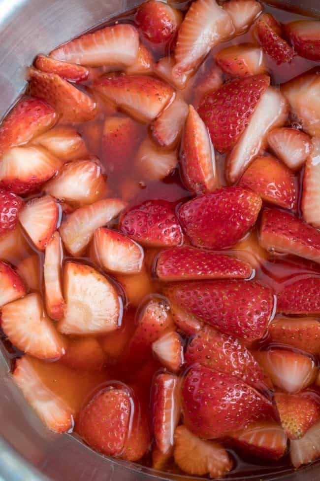 A bowl filled with chopped fruit in juice.