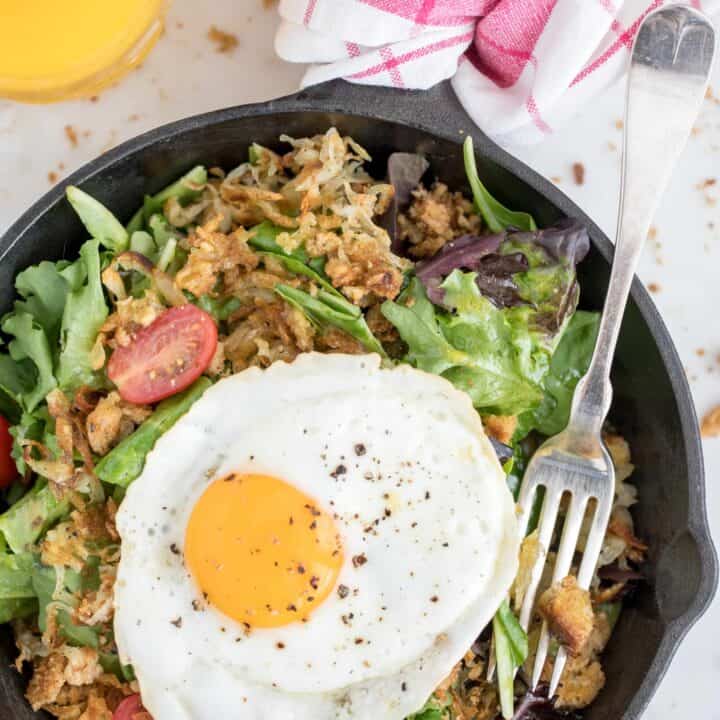 bowl of greens with fried eggs