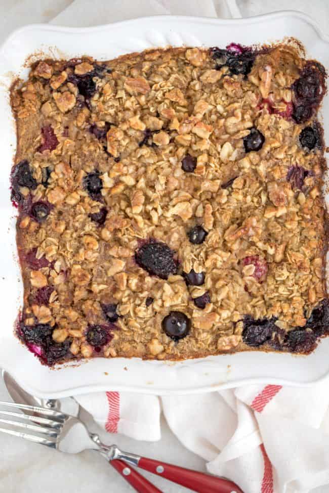 A white baking dish filled with berry baked oatmeal.