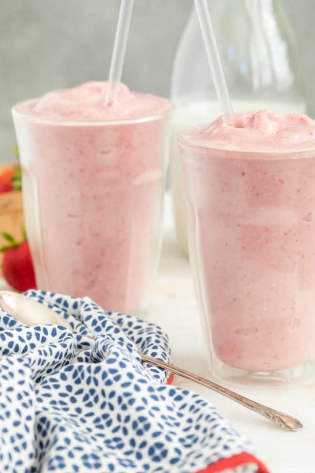 Two glasses of strawberry smoothie.