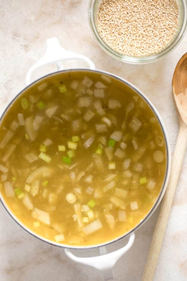 pan with onion and garlic simmering in vegetable broth