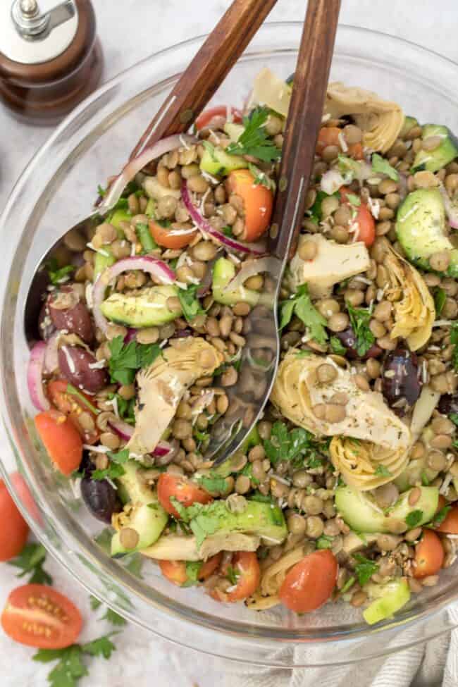 A glass bowl of lentil Mediterranean salad.
