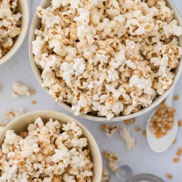 Three white bowls filled with homemade kettle corn.