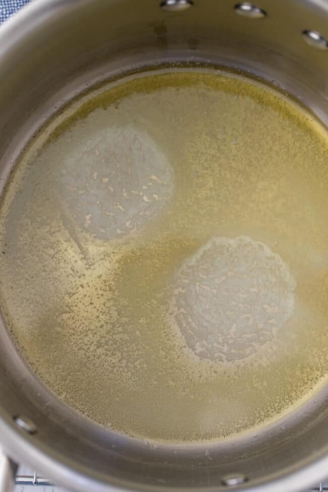 A saucepan with melted butter and oil.
