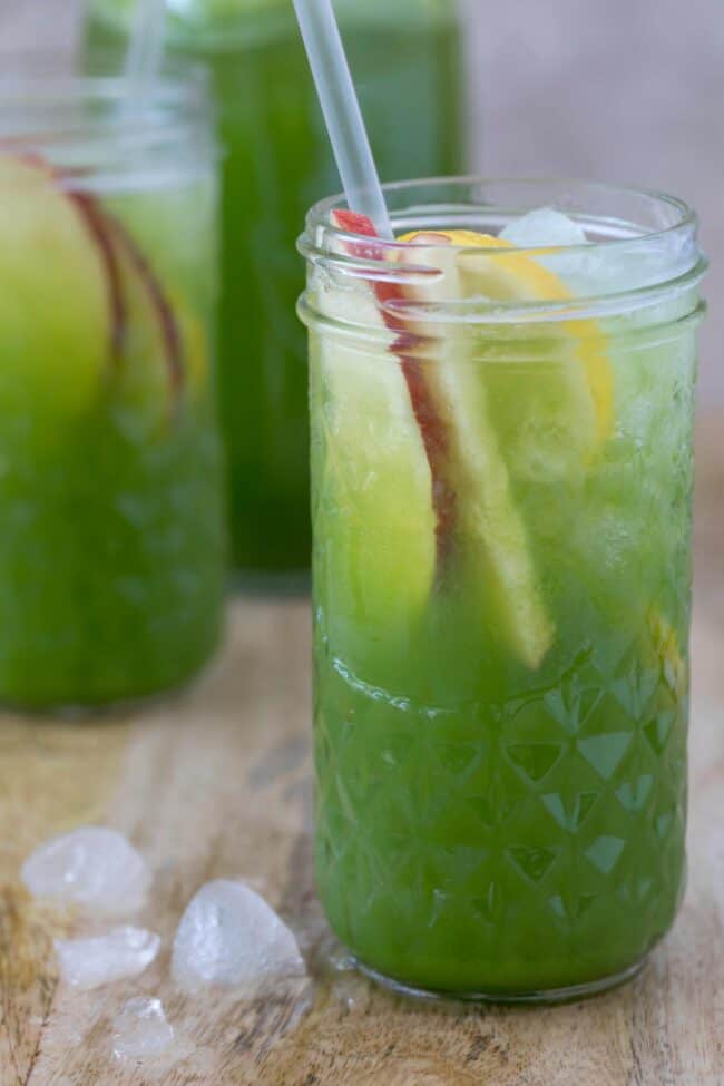 Three clear drinking glasses filled with celery juice.