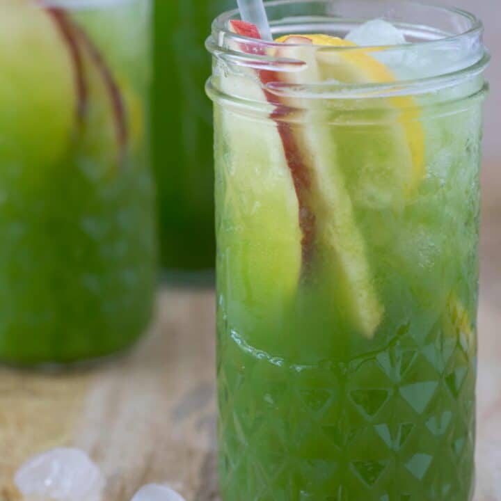 Two clear drinkig glasses filled with celery juice.