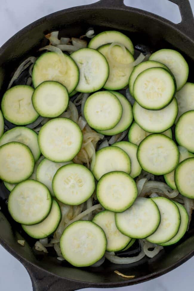 skillet of onions and zucchini for zucchini side dish