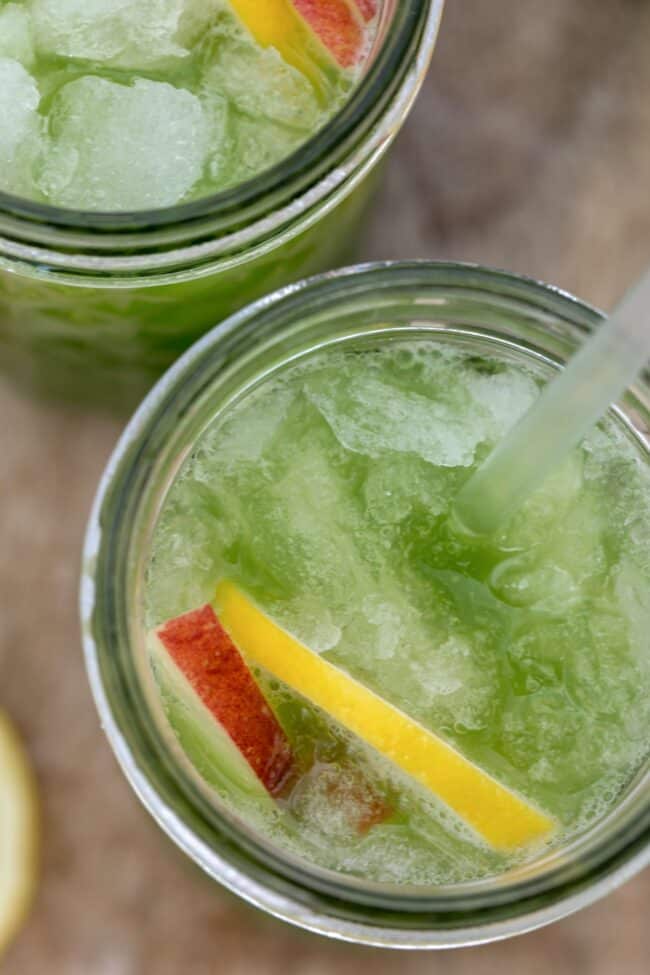 Two clear drinking glasses filled with celery juice.