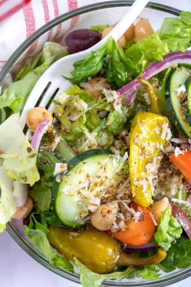 A bowl of salad tossed with homemade Italian vinaigrette.