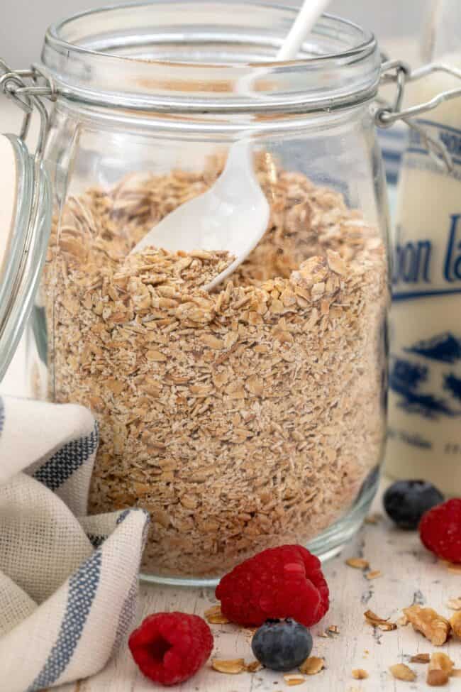 A clear glass jar of rolled oats.