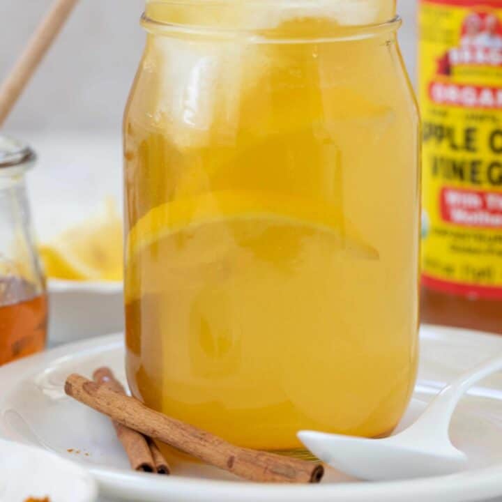 A clear glass mason jar filled with Apple cider vinegar drink.