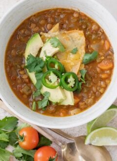 A white bowl of Mexican lentil soup.