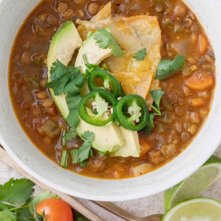 A white bowl of Mexican lentil soup.