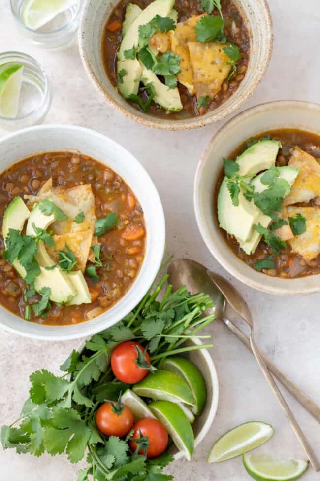 Three bowls of Mexican lentil soup (sopa de lentejas).