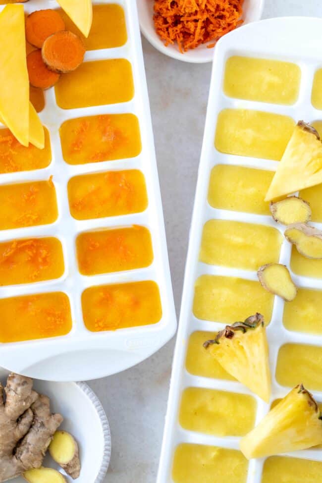 Two white trays filled with frozen fruit.