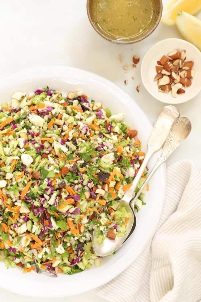 A large white bowl filled with chopped vegetables for a crunchy detox salad.