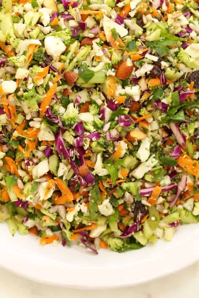 A white bowl filled with chopped vegetables for a crunchy salad.