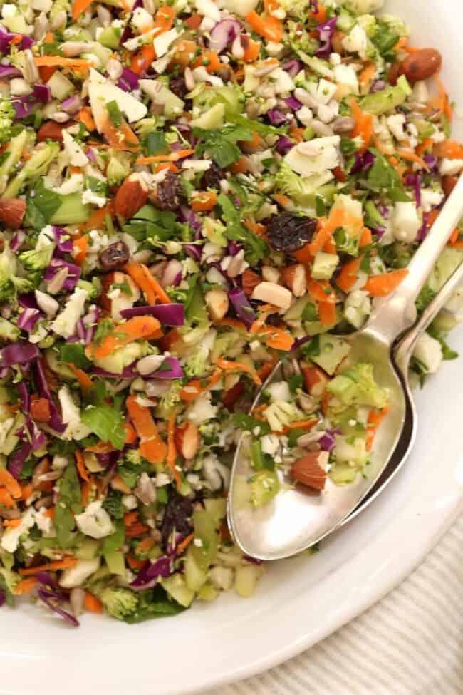 A white bowl filled with finely chopped vegetables for crunchy salad.