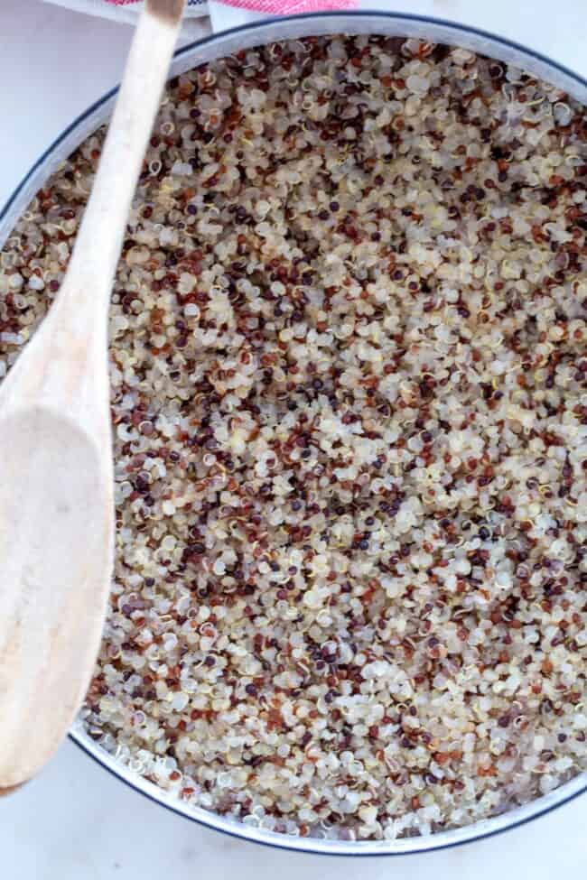 A white pot of cooked grains.