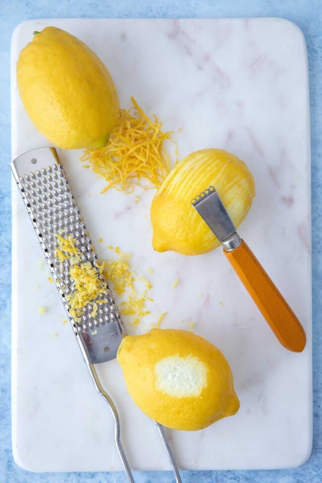 A metal zester next to a pile of grated citrus with d limonene