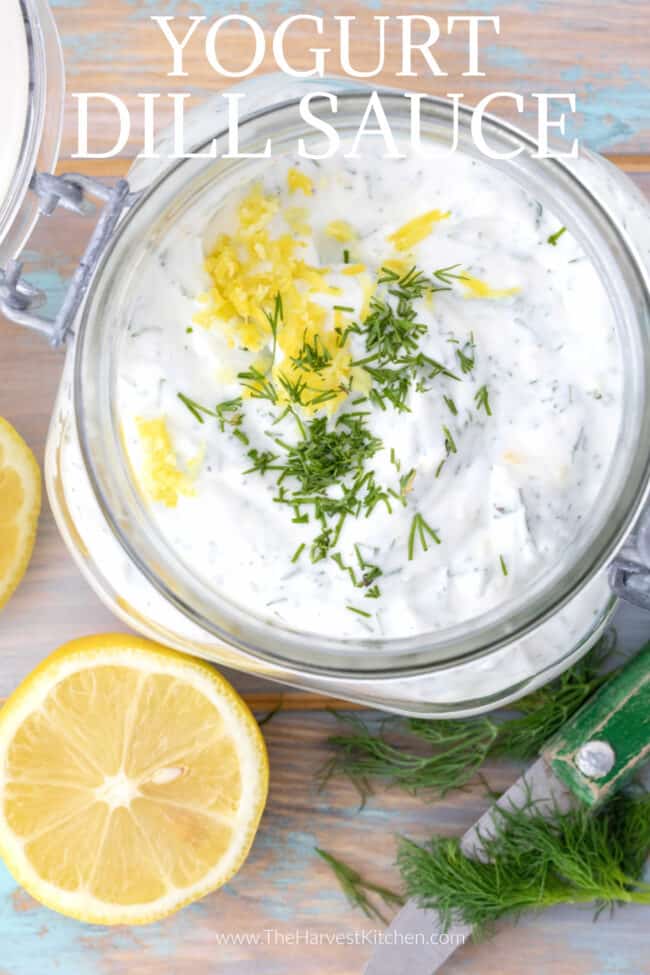 A clear mason jar filled with yogurt dill sauce.