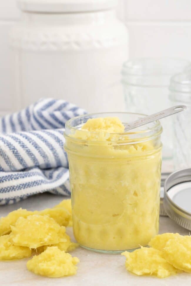 A clear glass mason jar filled with ginger paste.