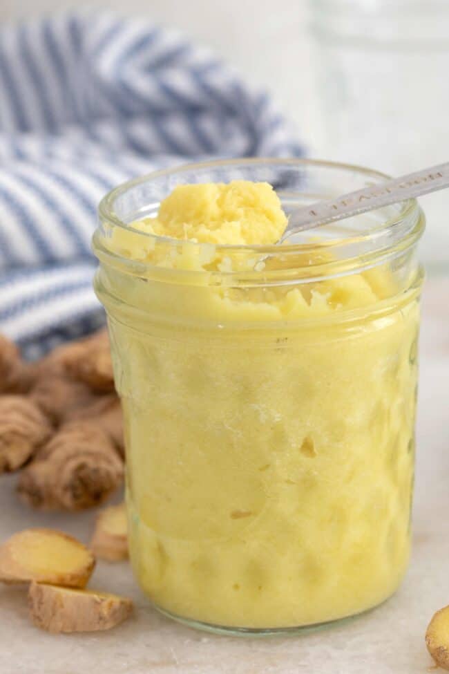 A clear glass jar filled with ginger paste.