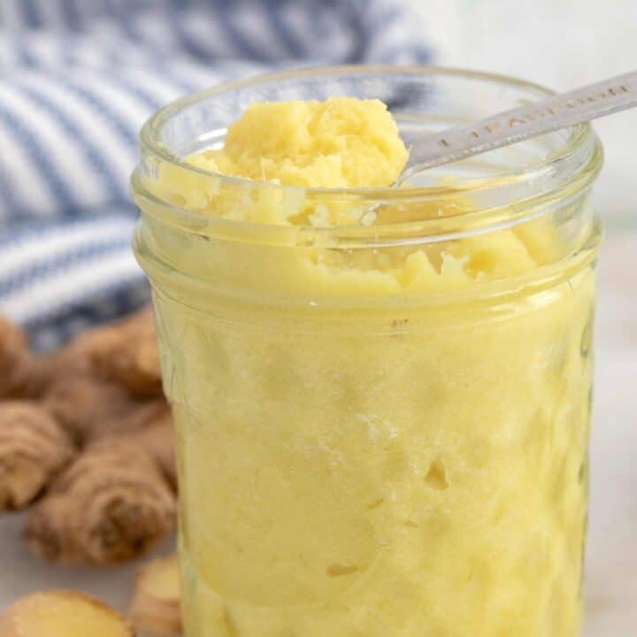 A clear glass jar filled with ginger paste.